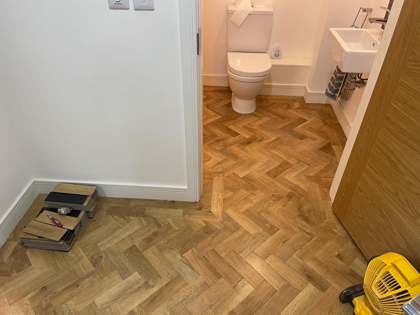 Parquet style LVT flooring installed in bathroom